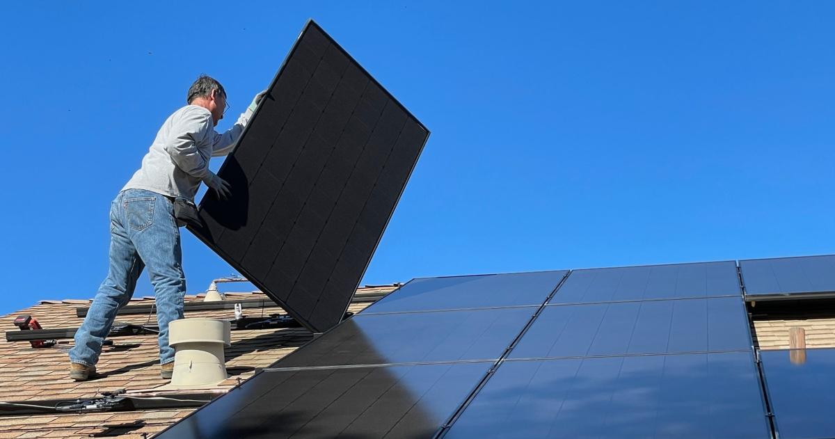 A man installing solar panels