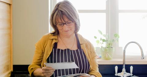 Woman holding an AARP membership invitation.