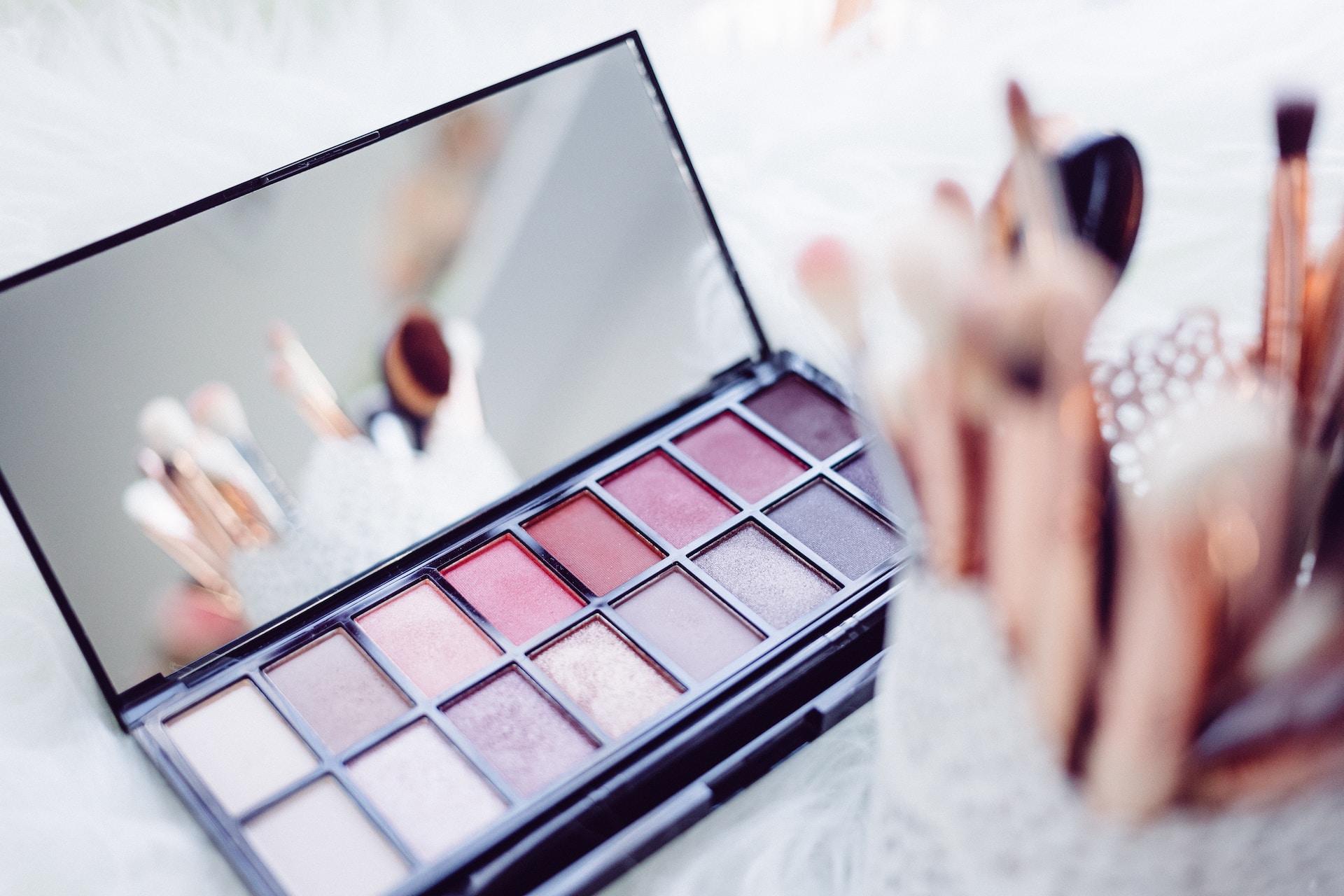 A cool-tone pink eyeshadow set seen on a countertop