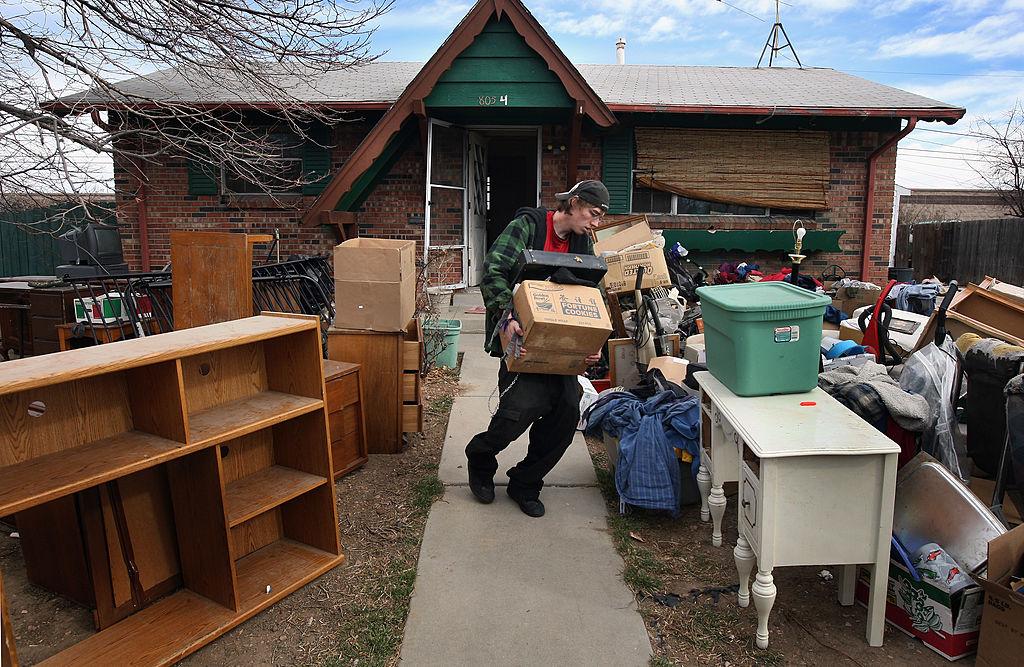 A man moving out of a foreclosed home.