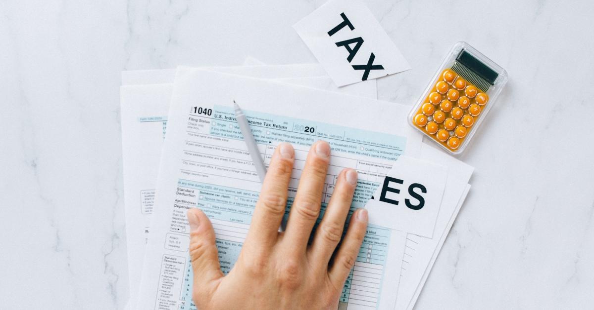 The word taxes cut in half over tax forms.