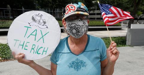 Protestor calling for taxing the rich