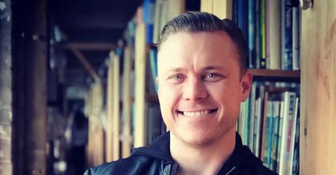 Bob Lee smiling in front of bookcases