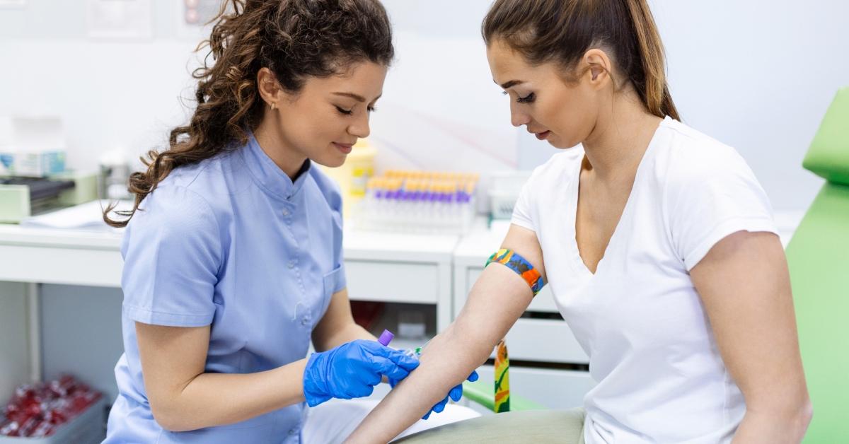 A phlebotomist preparing to draw blood.