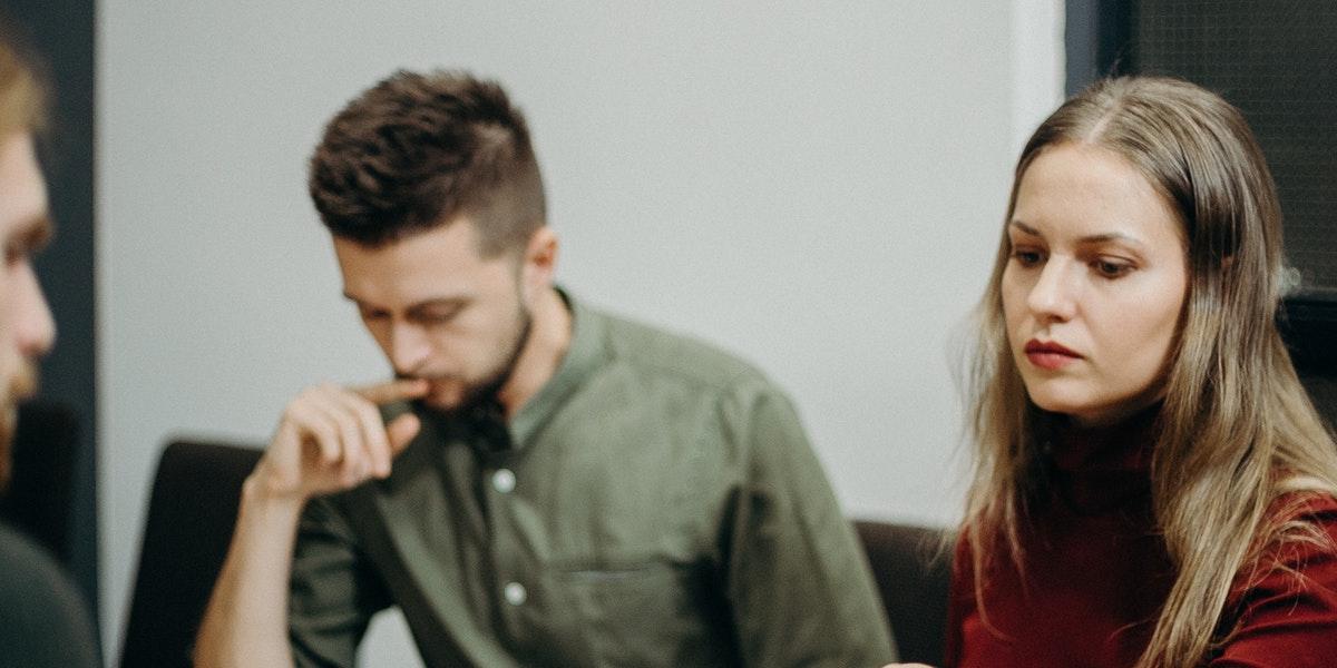 A man and woman signing up for unemployment benefits