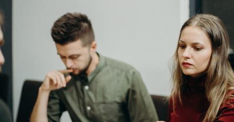 A man and woman signing up for unemployment benefits